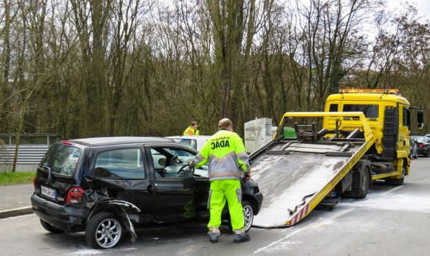 a man towing a car from accident